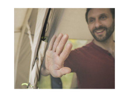 Persontouching a mesh netting door with a blurred background
