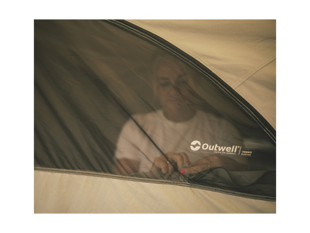 Person inside a tent with Outwell branding on a white background