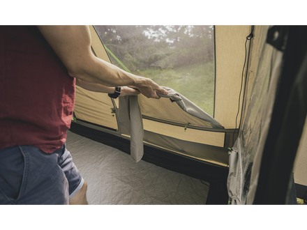 Person rolling down a  tent window 