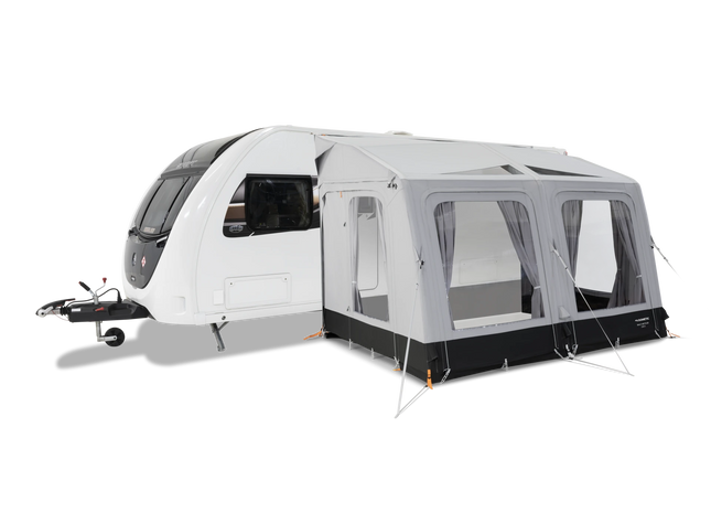 Caravan with an attached awning on a white background