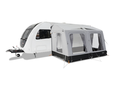 Caravan with an attached awning on a white background