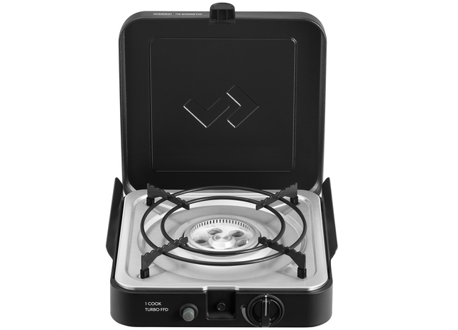 Portable gas stove with a black lid on a white background