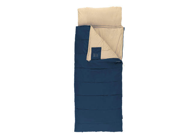 A single sleeping bag shown from above on a plain white background, with a navy blue exterior and a light beige interior. A matching light beige pillow is placed at the top, and a small dark blue fabric tag is visible near the opening.