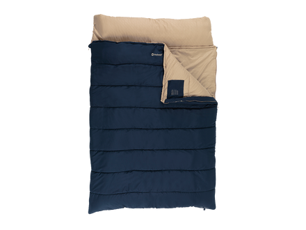 A puffer sleeping bag shown flat against a white background, featuring a dark navy blue exterior and a beige interior lining with a folded corner revealing both colors.