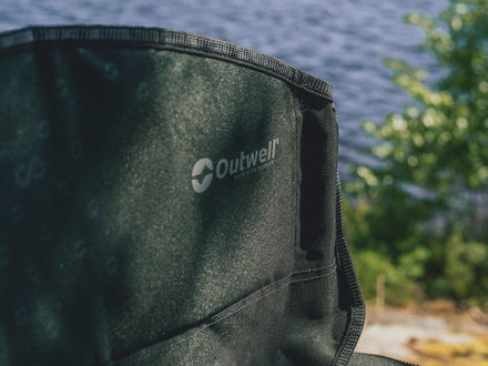 Close-up of a green Outwell product with a blurred natural background