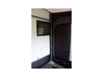 support pole holding an awning up to a caravan