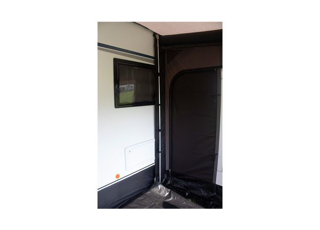 support pole holding an awning up to a caravan