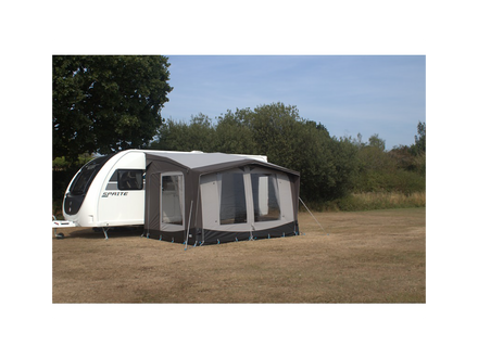 Caravan with an attached awning in a natural setting