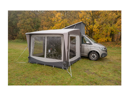 Awning attached to a van in a forest setting