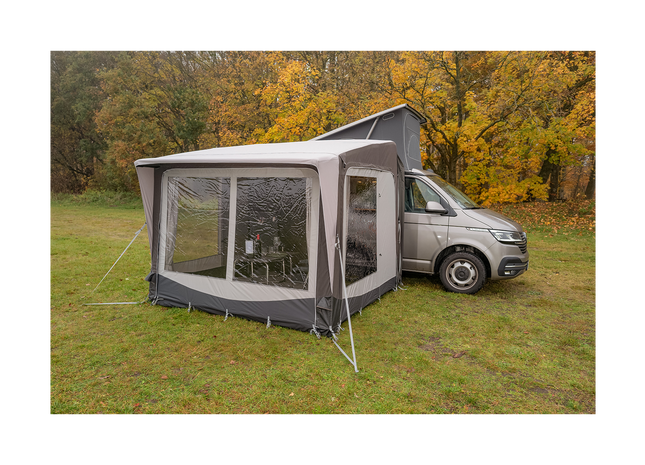 Awning attached to a van in a forest setting