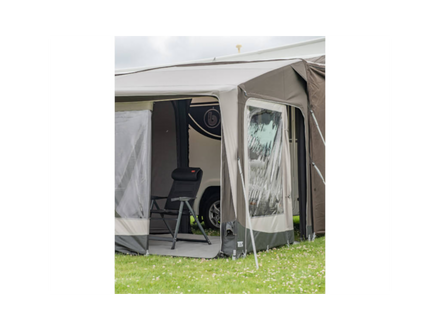 Caravan with an awning extended on a grassy area