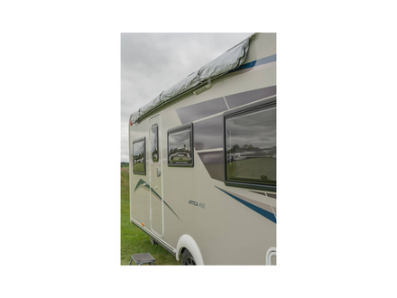 Camper van parked outdoors with a cloudy sky
