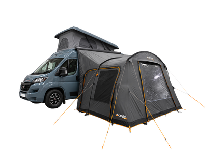 A dark gray and black Vango air awning with orange trim, shown attached to the side of a blue-gray camper van with a pop-top on a plain white background.