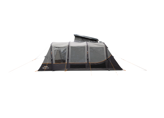A dark gray and black air awning, shown pitched beside a dark gray motorhome on a plain white background.