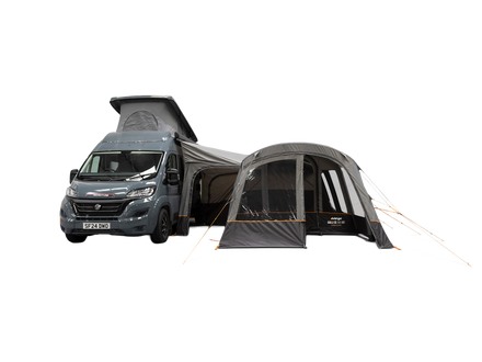 A dark gray and black air awning, shown pitched beside a dark gray motorhome on a plain white background.