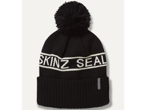 Black beanie with pom-pom and 'SKINZ SEAL' branding on a white background