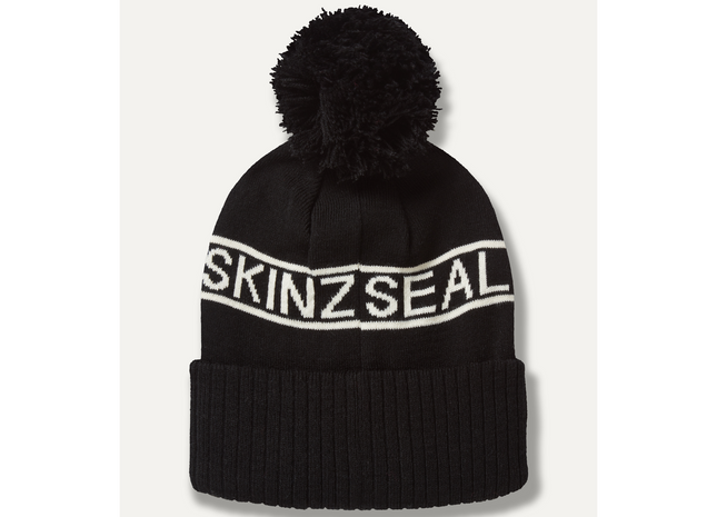 Black beanie with pom-pom and 'SKINZSEAL' branding on a white background