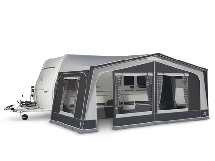 Caravan with an attached awning on a white background