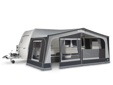 Caravan with an attached awning on a white background