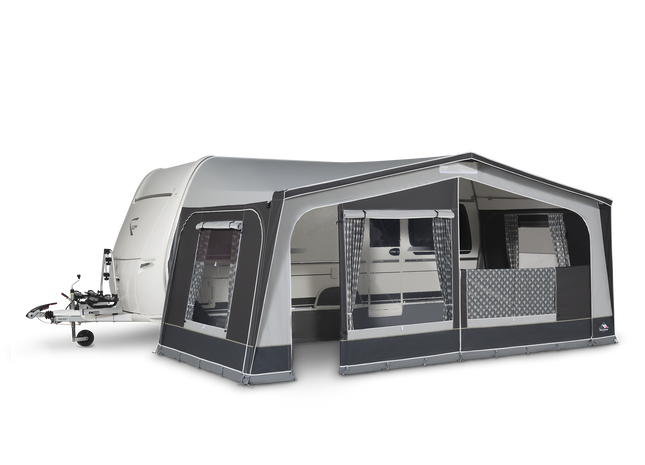 Caravan with an attached awning on a white background