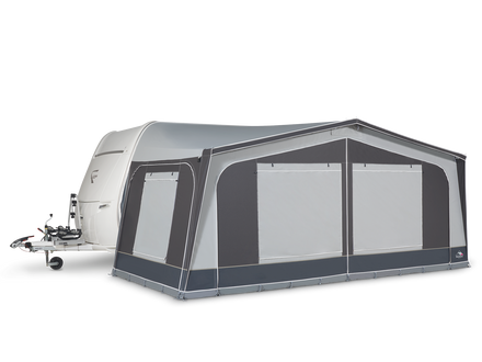 Caravan with an attached awning on a white background