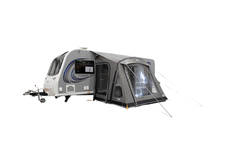 Caravan with an attached awning on a white background