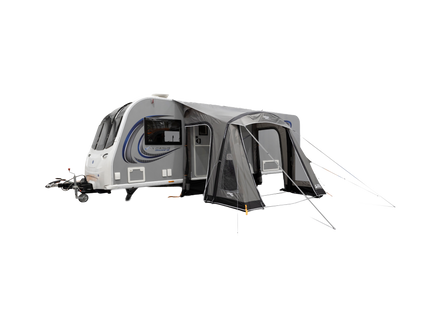 Caravan with an attached awning on a white background