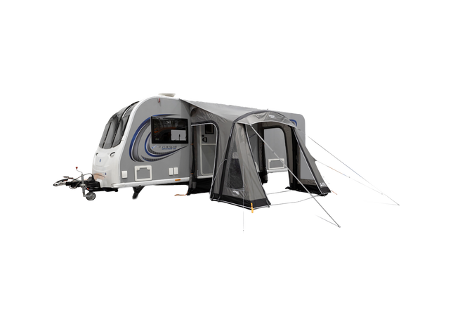 Caravan with an attached awning on a white background