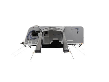Camper trailer with an attached canopy on a white background