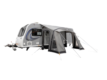 A white and gray travel trailer with an attached gray awning and mesh door, shown on a plain white background.