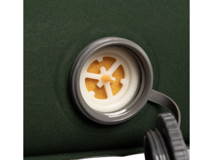 Close-up of a inflation valve on a green sleeping mat