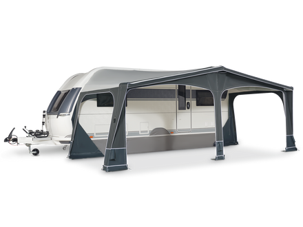 Caravan with a gray awning on a white background