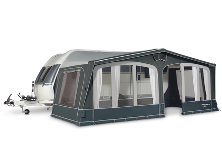 Caravan with an attached awning on a white background