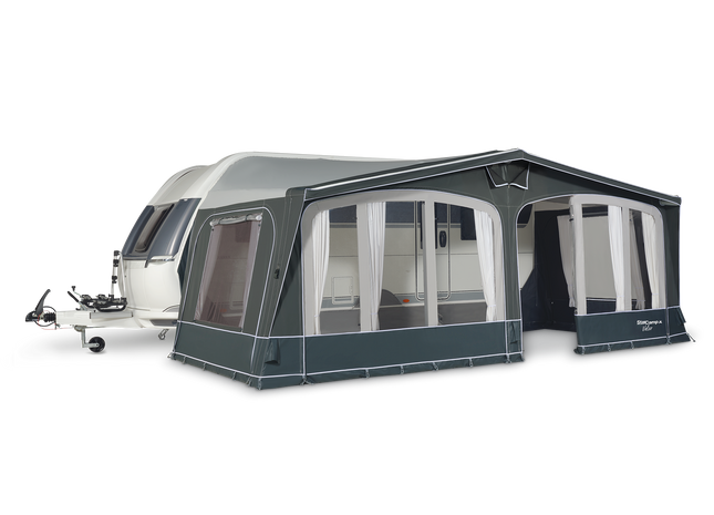 Caravan with an attached awning on a white background