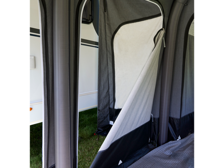 Camping tent interior with a view of the outside through the door