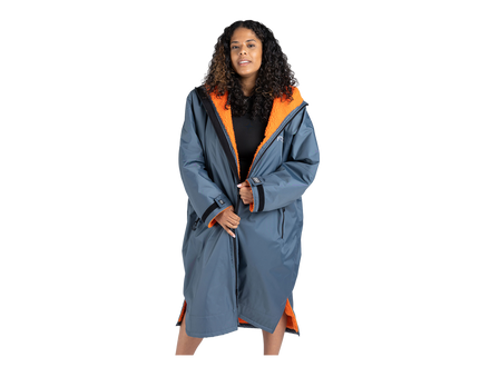 A woman modeling a long blue-gray hooded changing robe with a bright orange interior lining, shown against a plain white background.