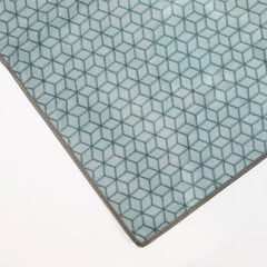 Close-up of a geometric patterned carpeton a white background