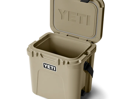 Tan YETI cooler with open lid on a white background