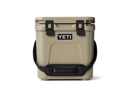 Tan YETI cooler with black straps on a white background